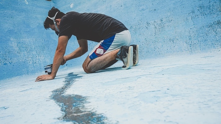 Young man working in his swimming pool